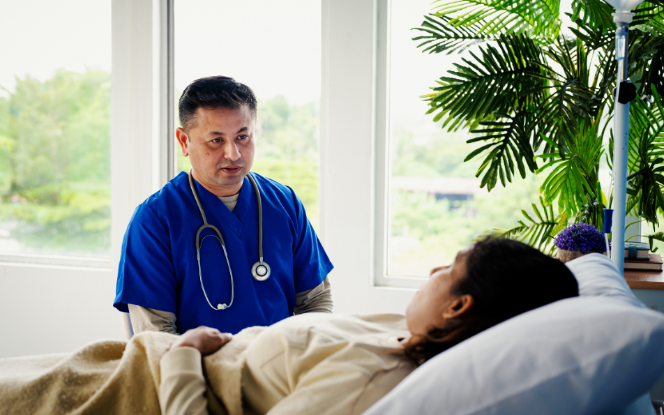 patient talking to doctor from bed
