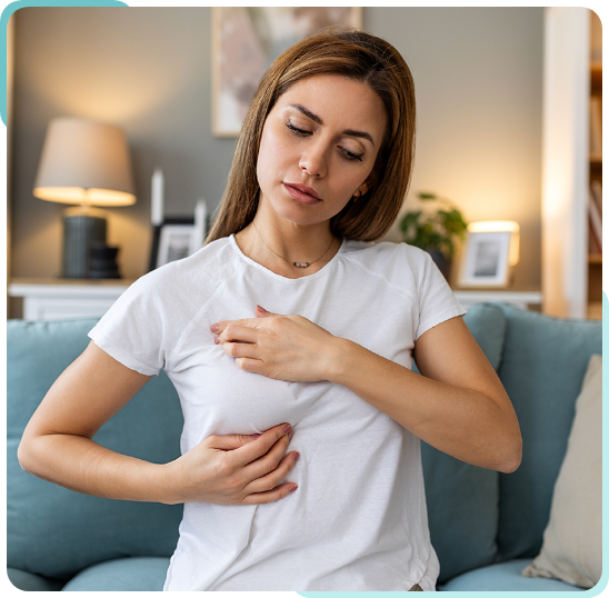 woman checking breast for cancer